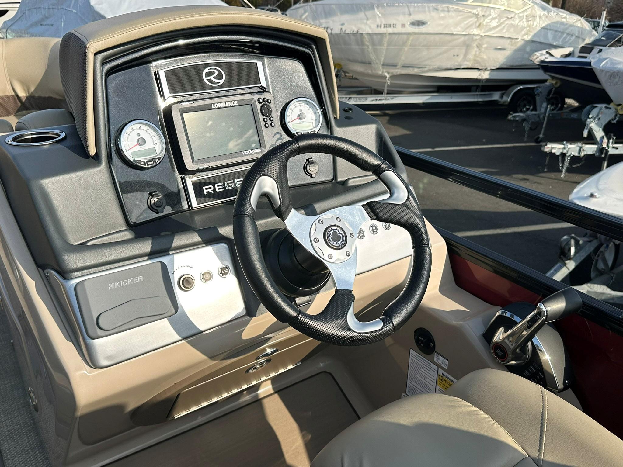 2023 Regency 230 DL3 boat dashboard with steering wheel and control panel.