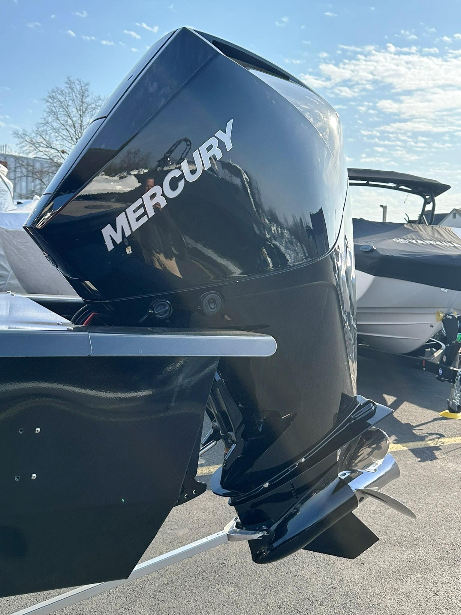 2023 Regency 230 DL3 with Mercury outboard motor under clear sky.