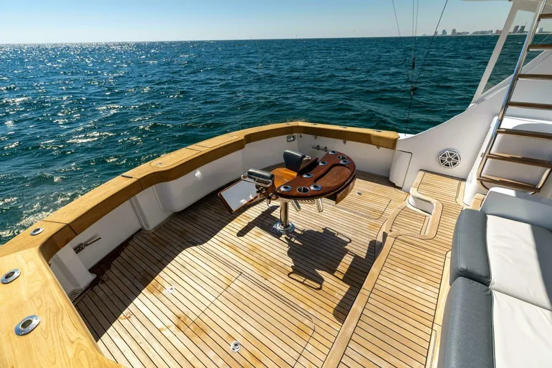  Yacht Photos Pics Luxurious 2012 Hatteras 60 GT yacht deck with ocean view and fishing chair.