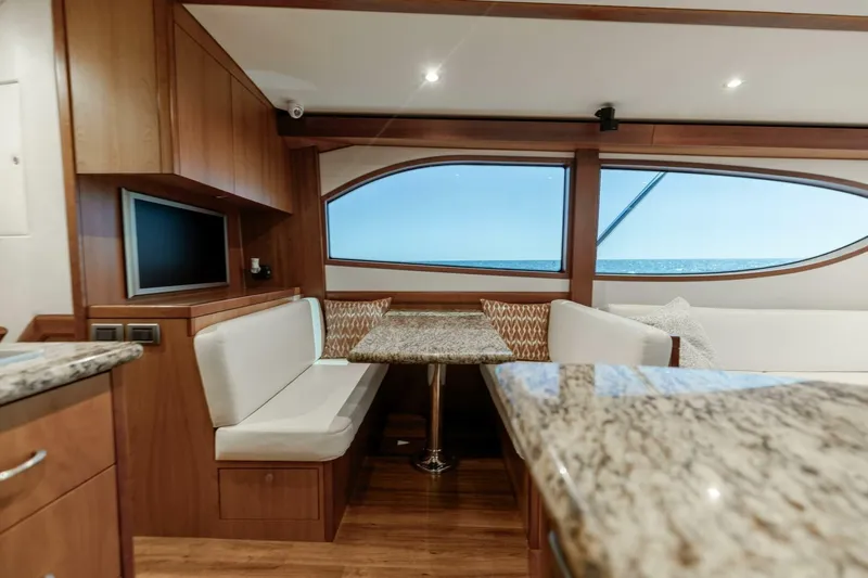  Yacht Photos Pics Luxurious interior of 2012 Hatteras 60 GT yacht with elegant seating and ocean view.
