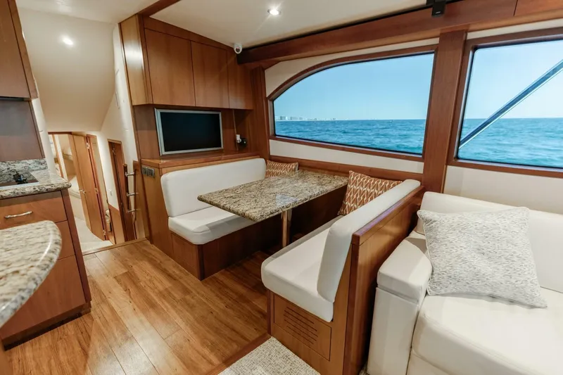  Yacht Photos Pics Luxurious interior of 2012 Hatteras 60 GT yacht with ocean view and elegant seating.