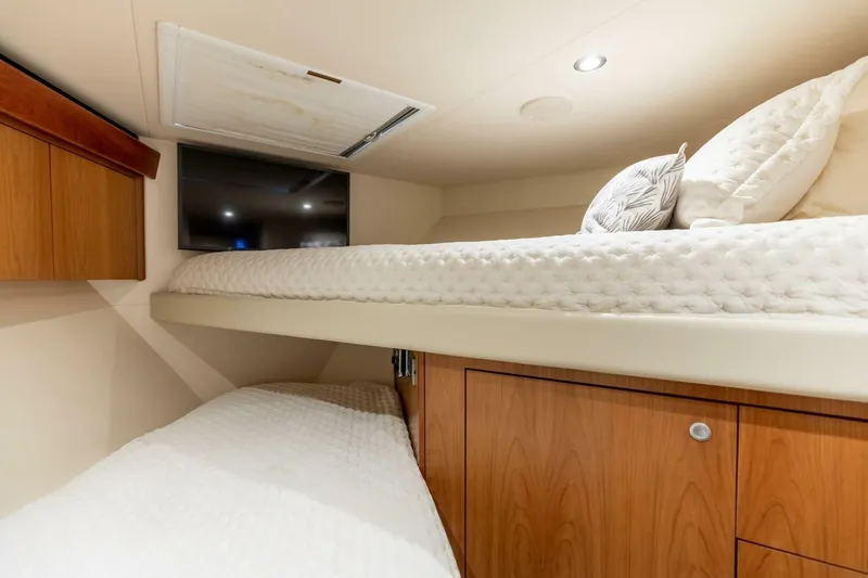  Yacht Photos Pics Cozy cabin interior of 2012 Hatteras 60 GT yacht with bunk beds and TV.