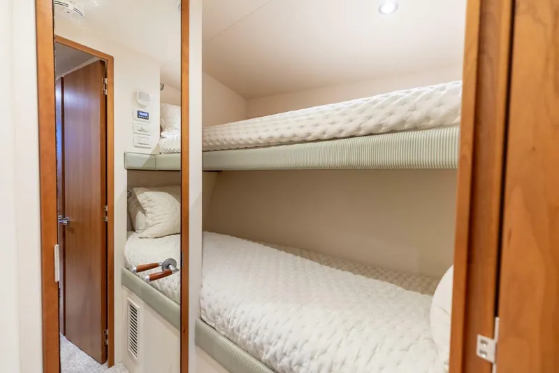  Yacht Photos Pics Bunk beds in 2012 Hatteras 60 GT yacht cabin with wooden accents.