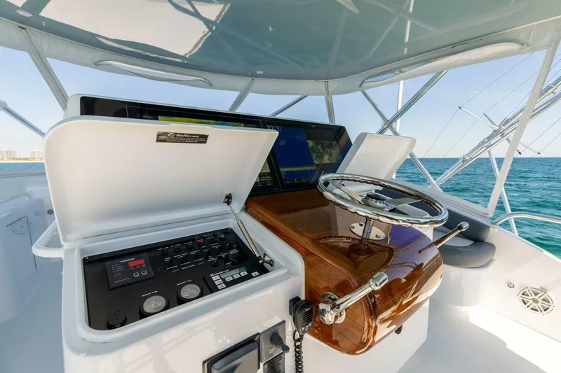  Yacht Photos Pics Helm of 2012 Hatteras 60 GT yacht with steering wheel and control panel.