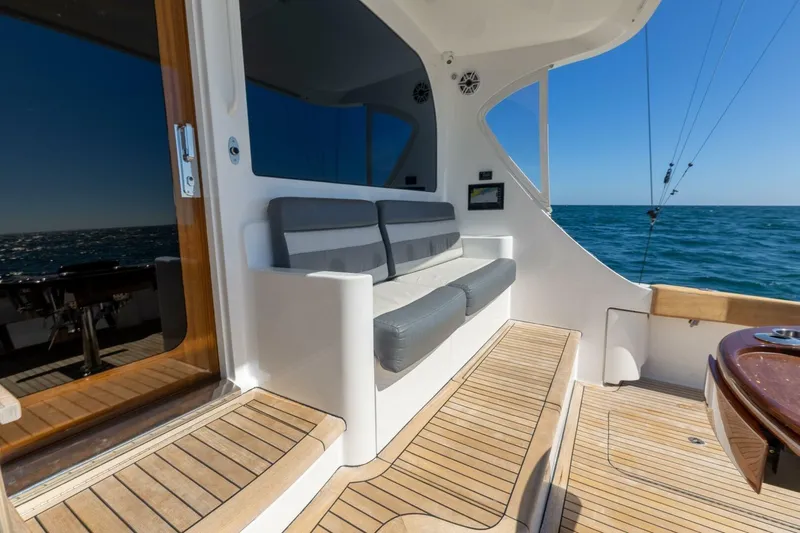  Yacht Photos Pics Luxury 2012 Hatteras 60 GT yacht deck with seating, ocean view, and wooden flooring.