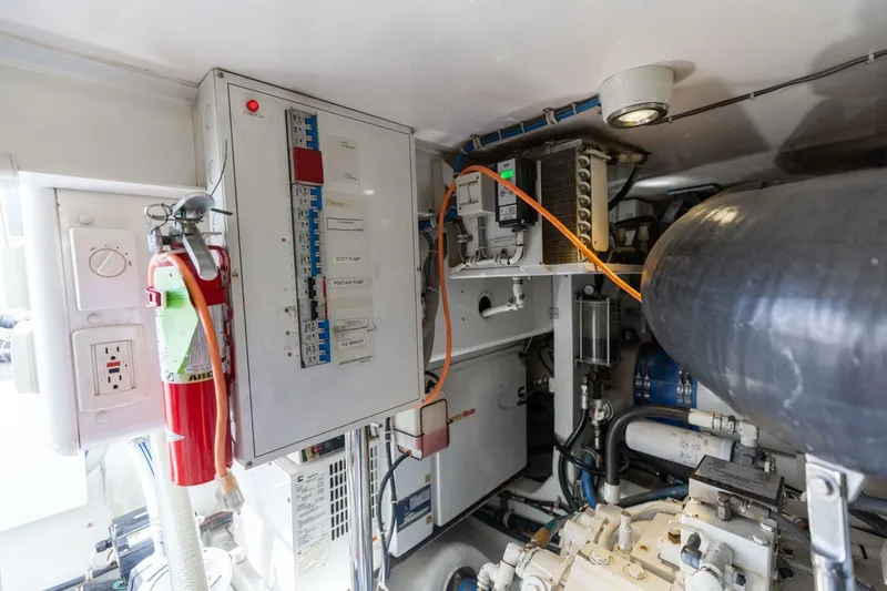  Yacht Photos Pics Engine room of 2012 Hatteras 60 GT yacht with control panel and fire extinguisher.