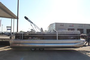 2025 Sun Tracker SportFish 22 DLX pontoon boat parked outdoors.