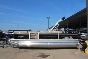 2025 Sun Tracker SportFish 22 DLX pontoon boat docked outdoors.