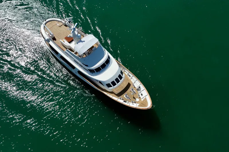 Lady Dina Yacht Photos Pics Aerial view of 1989 Moonen 85 Long Range Cruiser yacht on green water.