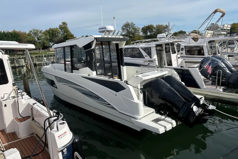  Yacht Photos Pics 2020 Beneteau Barracuda 9 boat docked in a marina, featuring twin outboard engines.