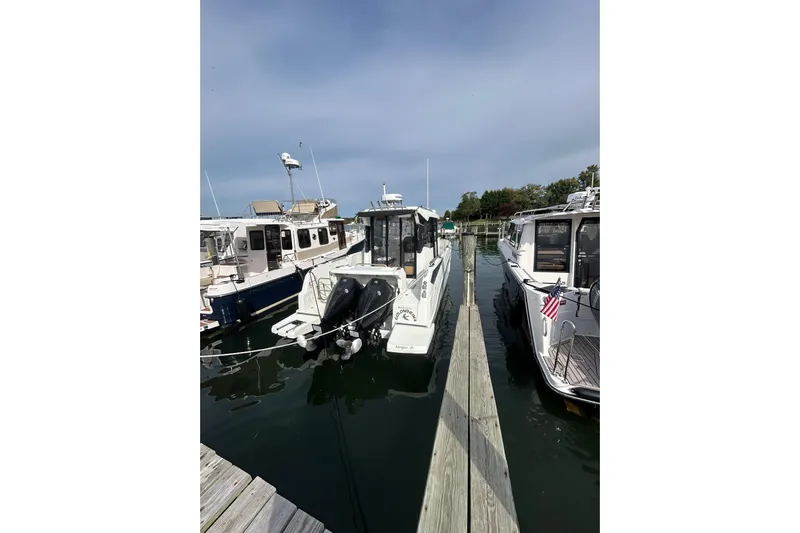  Yacht Photos Pics 2020 Beneteau Barracuda 9 docked between boats in a marina.