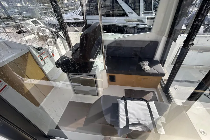  Yacht Photos Pics Interior view of 2020 Beneteau Barracuda 9 boat, featuring seating and helm area.