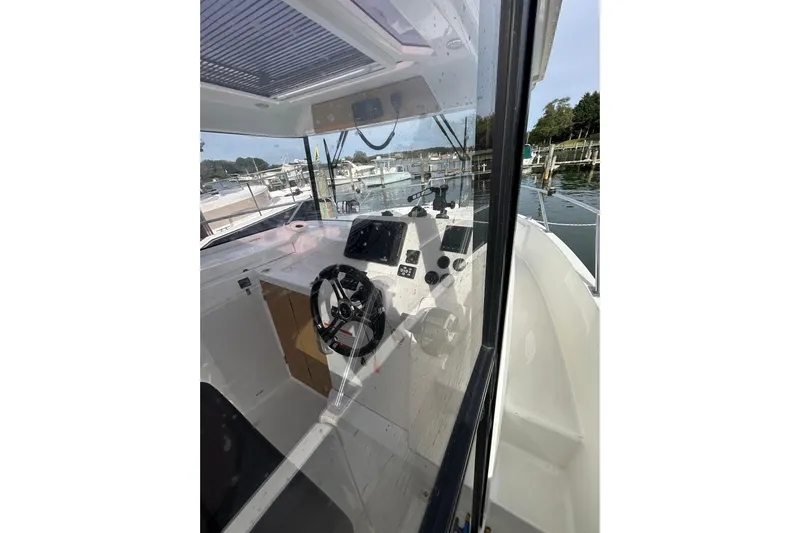  Yacht Photos Pics Interior view of 2020 Beneteau Barracuda 9 boat cockpit with steering wheel and controls.