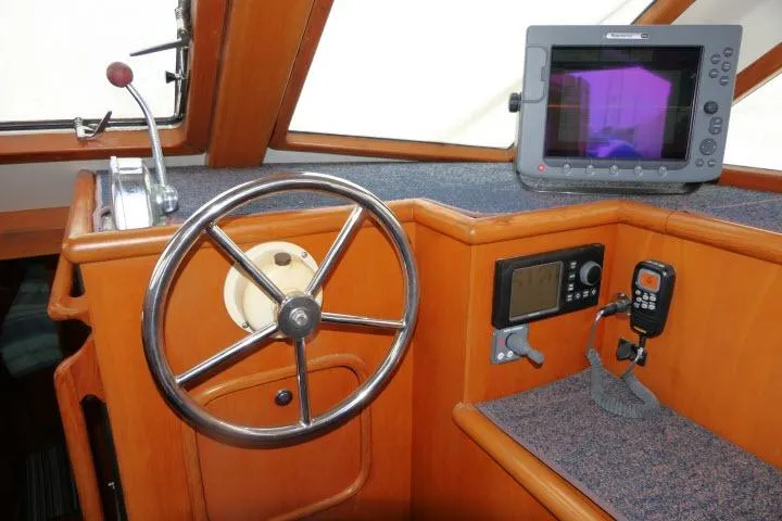 Sun Bird Yacht Photos Pics Pilothouse of 2002 Tayana 460 Vancouver with steering wheel and navigation equipment.