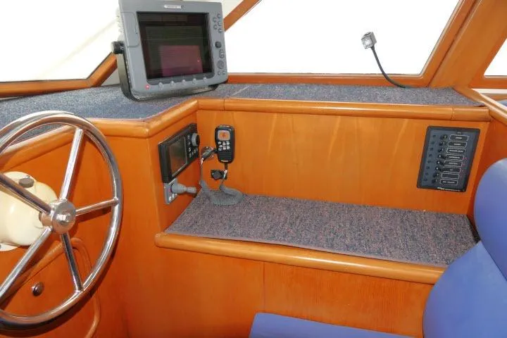 Sun Bird Yacht Photos Pics Pilothouse interior of 2002 Tayana 460 Vancouver, featuring navigation equipment and wooden finish.
