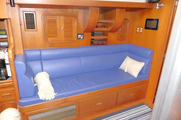 Sun Bird Yacht Photos Pics Luxurious 2002 Tayana 460 Vancouver Pilothouse interior with blue seating and wooden accents.