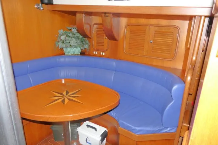 Sun Bird Yacht Photos Pics 2002 Tayana 460 Vancouver Pilothouse interior with blue seating and wooden table.