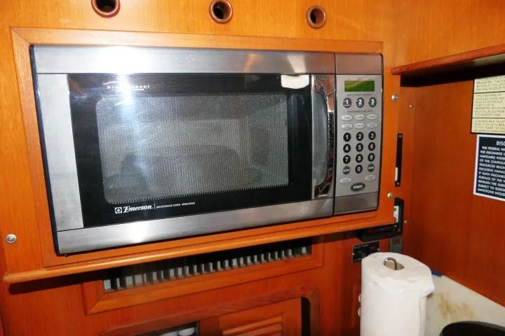 Sun Bird Yacht Photos Pics Microwave in 2002 Tayana 460 Vancouver Pilothouse kitchen, wooden cabinetry.