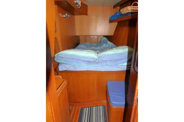 Sun Bird Yacht Photos Pics Cozy cabin interior of 2002 Tayana 460 Vancouver Pilothouse with wooden finish and bedding.