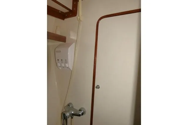 Sun Bird Yacht Photos Pics Bathroom interior of 2002 Tayana 460 Vancouver Pilothouse yacht, featuring shower and dispenser.