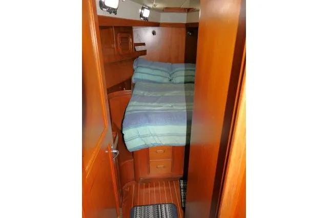 Sun Bird Yacht Photos Pics 2002 Tayana 460 Vancouver Pilothouse cabin with wooden interior and cozy bed.