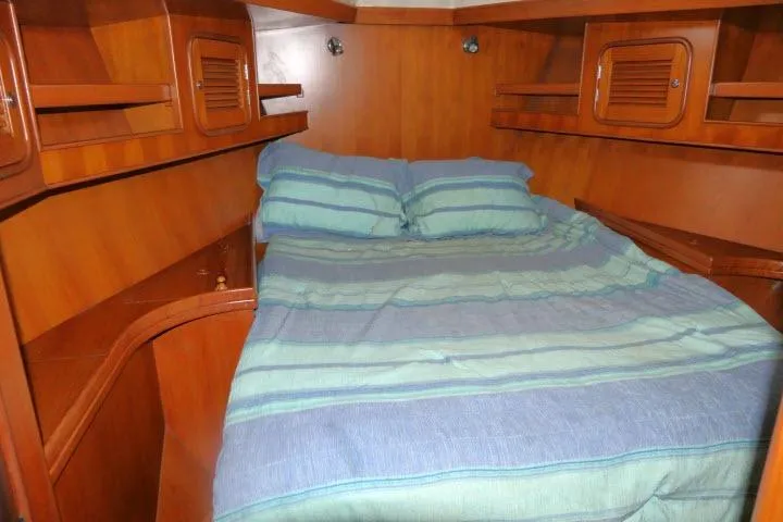 Sun Bird Yacht Photos Pics Cozy cabin interior of 2002 Tayana 460 Vancouver Pilothouse with striped bedding.