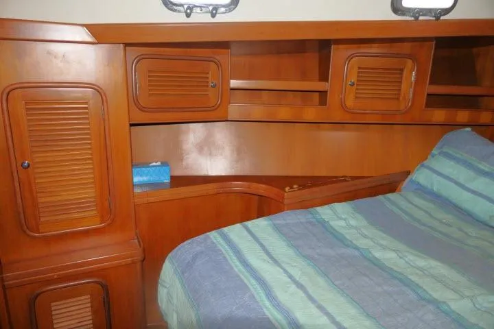 Sun Bird Yacht Photos Pics Interior cabin of 2002 Tayana 460 Vancouver Pilothouse with wooden storage and bed.