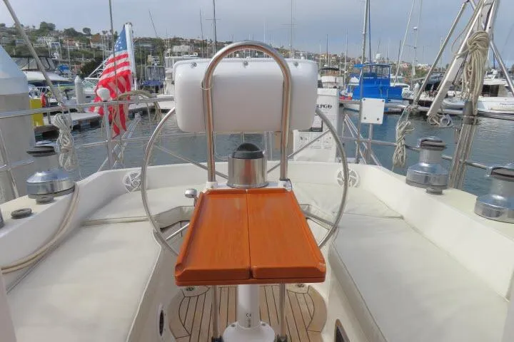 Sun Bird Yacht Photos Pics Tayana 460 Vancouver Pilothouse 2002 yacht cockpit with steering wheel and marina view.
