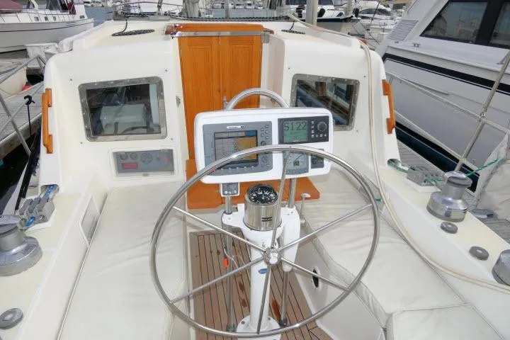 Sun Bird Yacht Photos Pics Pilothouse of 2002 Tayana 460 Vancouver yacht with navigation equipment and steering wheel.