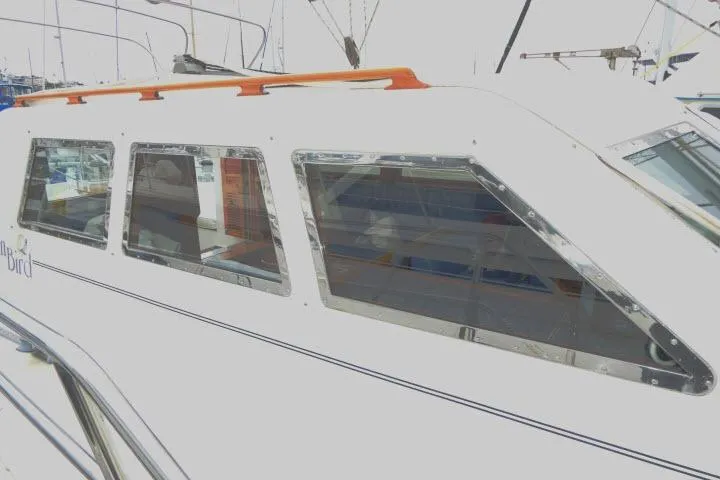 Sun Bird Yacht Photos Pics 2002 Tayana 460 Vancouver Pilothouse yacht with sleek windows and orange railings.