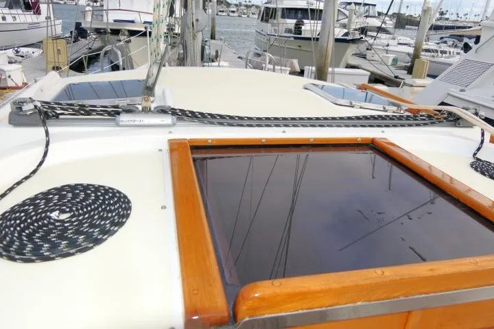 Sun Bird Yacht Photos Pics 2002 Tayana 460 Vancouver Pilothouse deck with ropes and hatch, docked at marina.