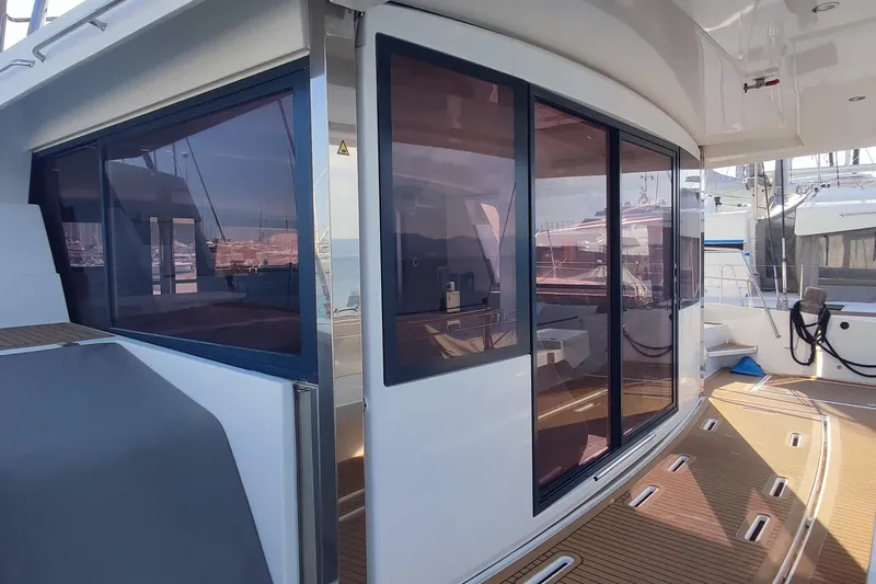 Helios Yacht Photos Pics Modern 2021 Bali 5.4 yacht with sleek design and tinted windows at a marina.