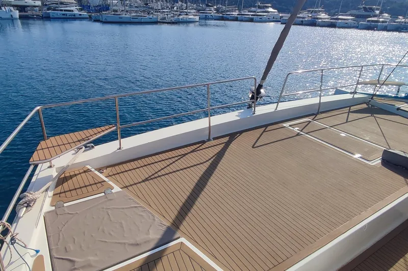 Helios Yacht Photos Pics Spacious deck of 2021 Bali 5.4 yacht in marina, overlooking calm blue waters.