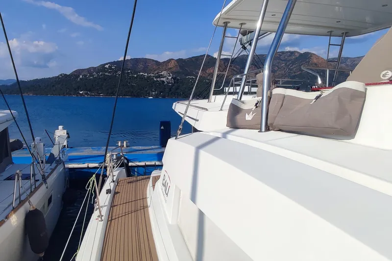 Helios Yacht Photos Pics Bali 5.4 yacht docked by scenic coastline, 2021 model.