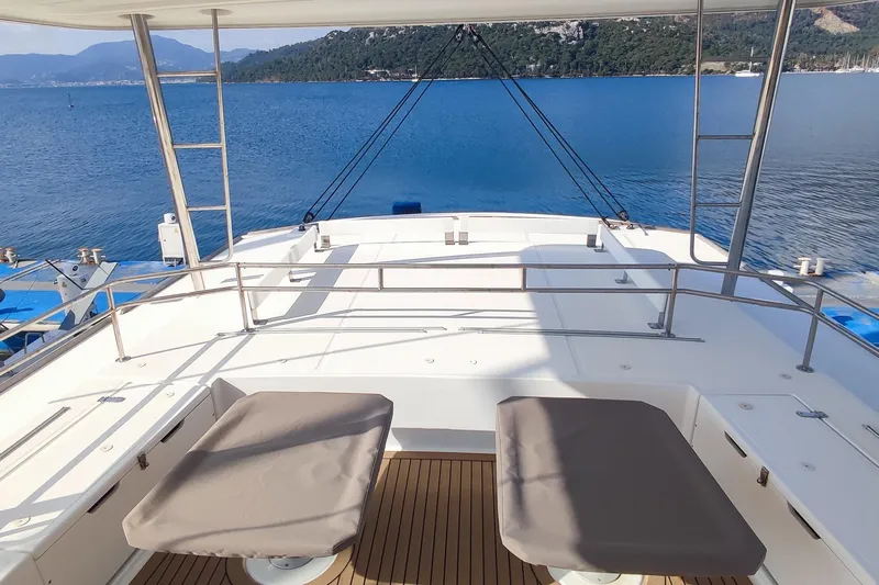 Helios Yacht Photos Pics Luxury Bali 5.4 yacht deck, 2021 model, overlooking serene blue waters and distant mountains.