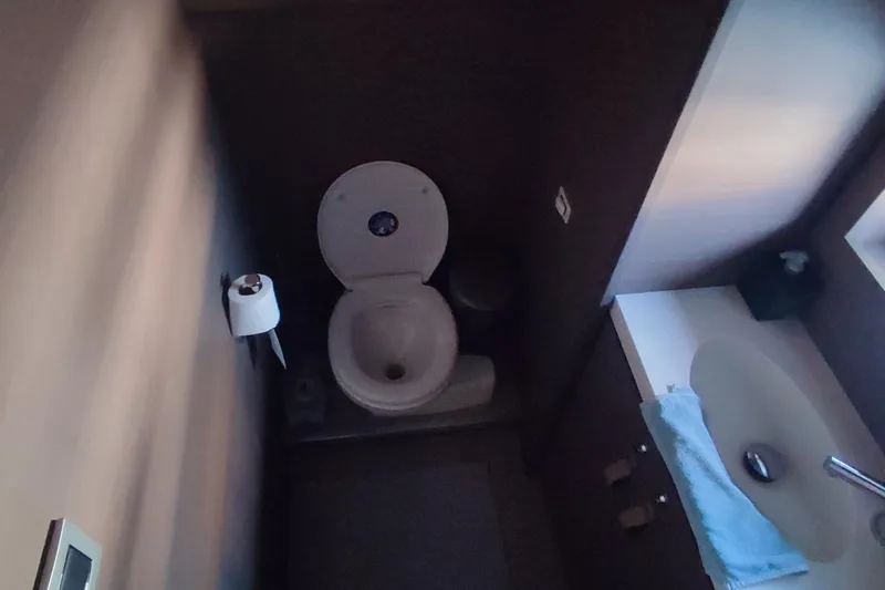 Helios Yacht Photos Pics Compact bathroom in a 2021 Bali 5.4 model, featuring a toilet and sink.