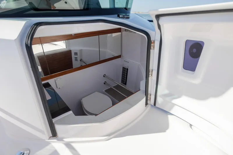  Yacht Photos Pics 2024 Axopar 28 CABIN boat interior with compact bathroom and modern design.