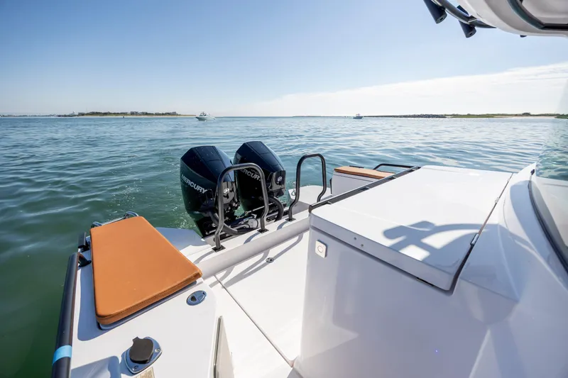  Yacht Photos Pics 2024 Axopar 28 CABIN boat with dual Mercury engines on calm water.