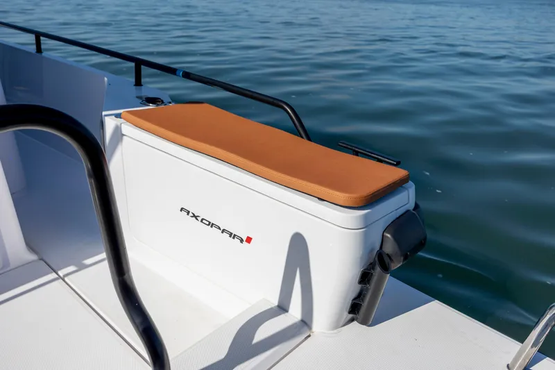  Yacht Photos Pics 2024 Axopar 28 CABIN boat seat with cushion, near water.