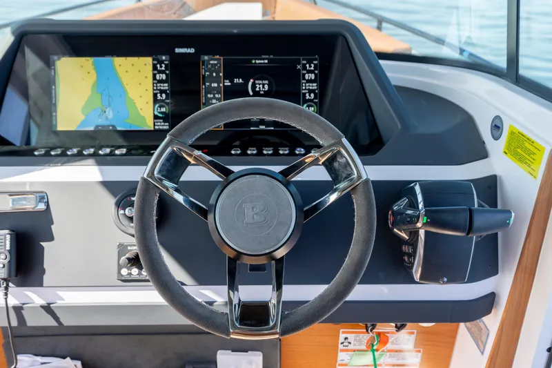  Yacht Photos Pics 2024 Axopar 28 CABIN dashboard with steering wheel and navigation display.