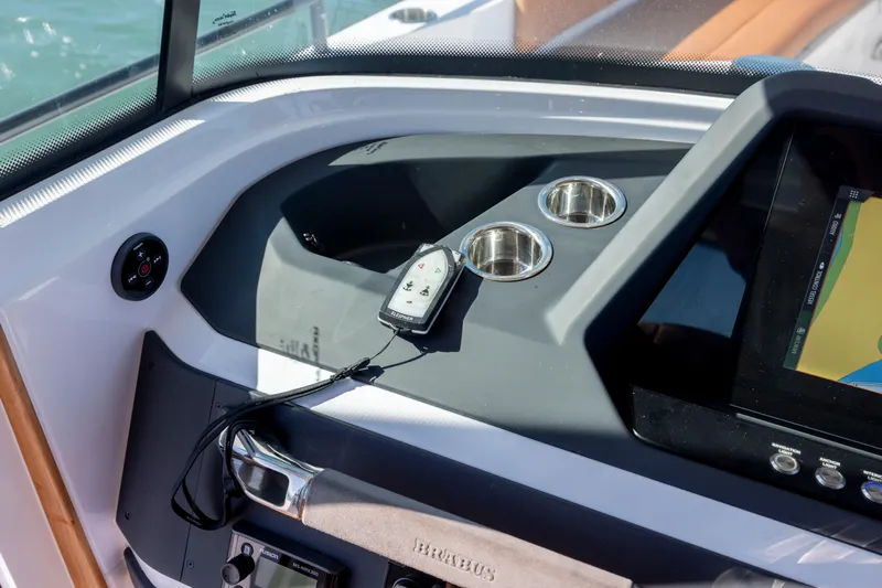  Yacht Photos Pics 2024 Axopar 28 CABIN dashboard with navigation screen and control panel.