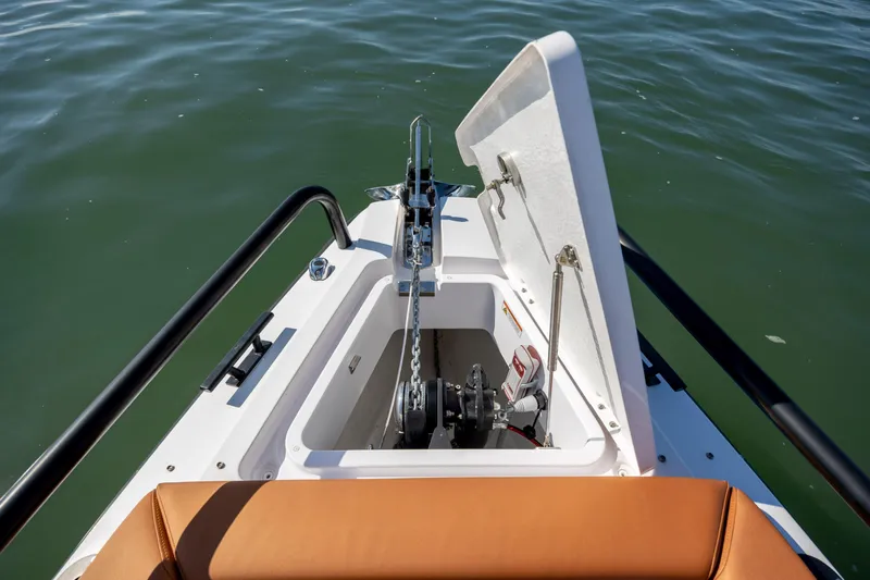  Yacht Photos Pics 2024 Axopar 28 CABIN anchor compartment with open hatch on calm water.