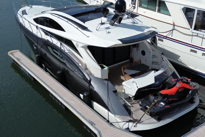  Yacht Photos Pics 2009 Marquis 500 Sport Coupe yacht docked with jet ski on deck.