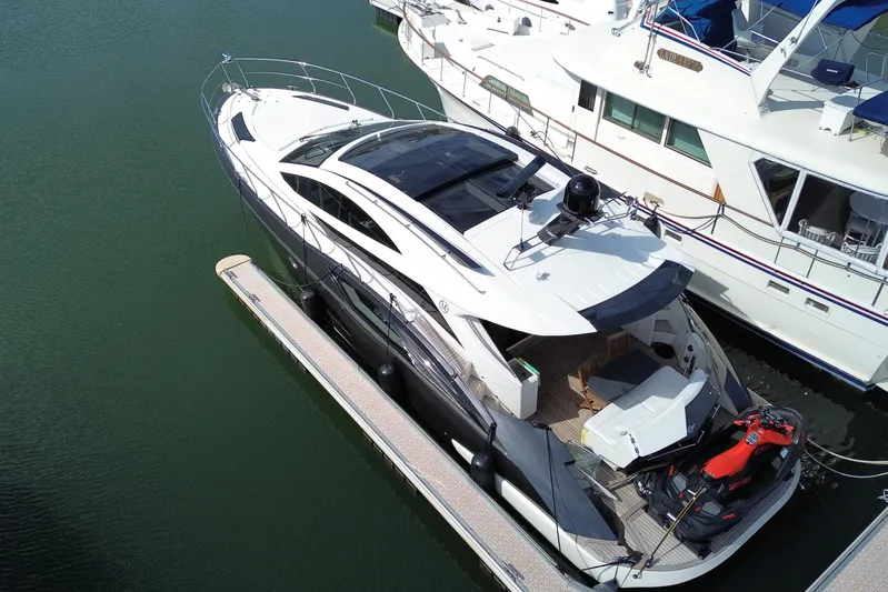  Yacht Photos Pics 2009 Marquis 500 Sport Coupe yacht docked with jet ski on deck.