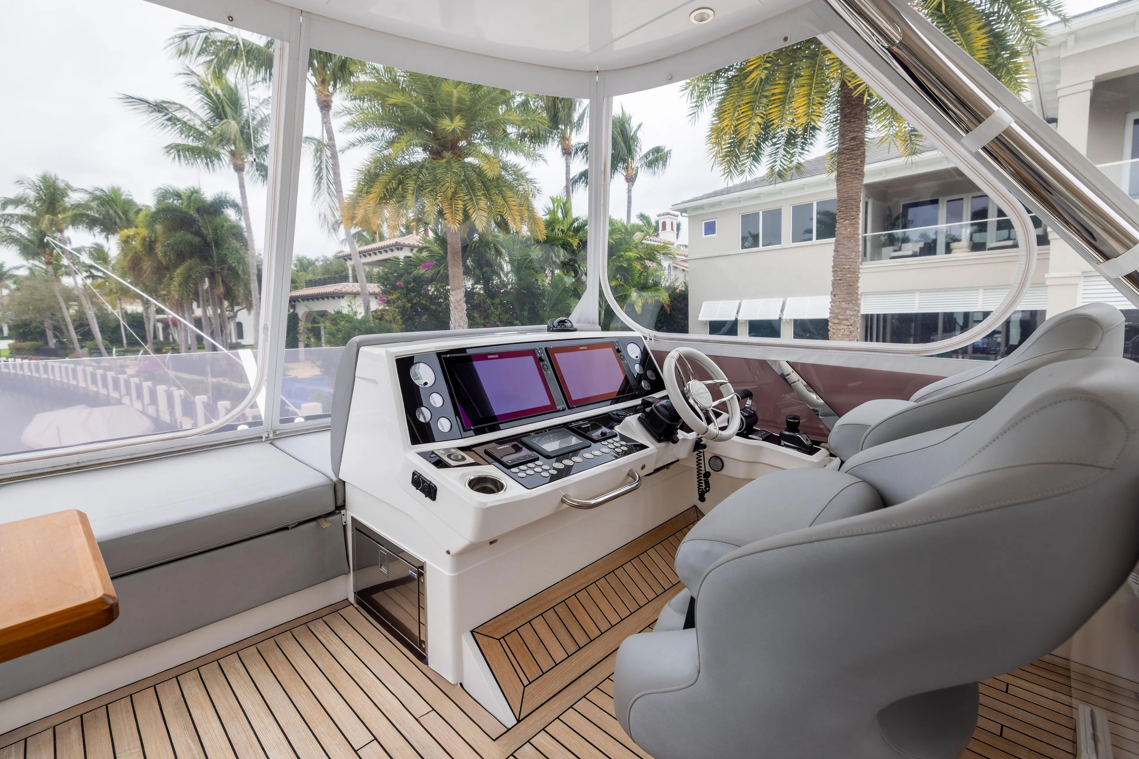 Journey Yacht Photos Pics Luxurious 2019 Sunseeker 76 yacht helm with modern controls and palm tree view.