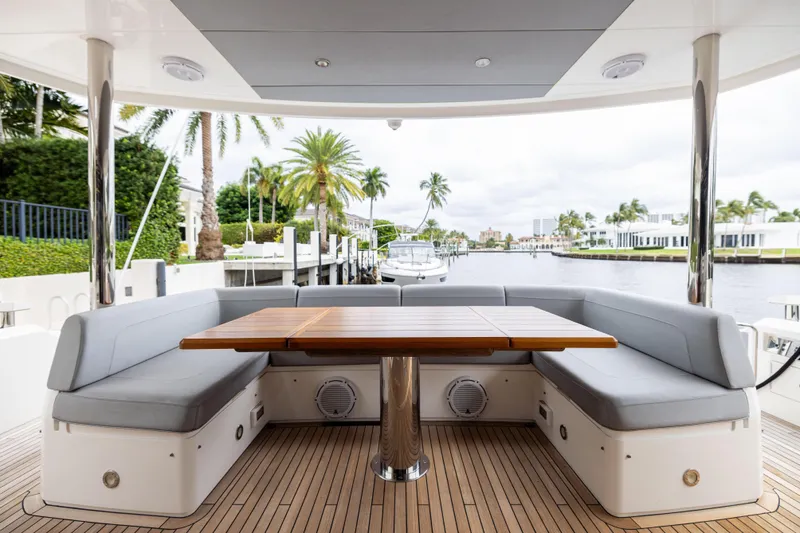 Journey Yacht Photos Pics Luxurious Sunseeker 76 yacht deck with seating, table, and waterfront view, 2019 model.