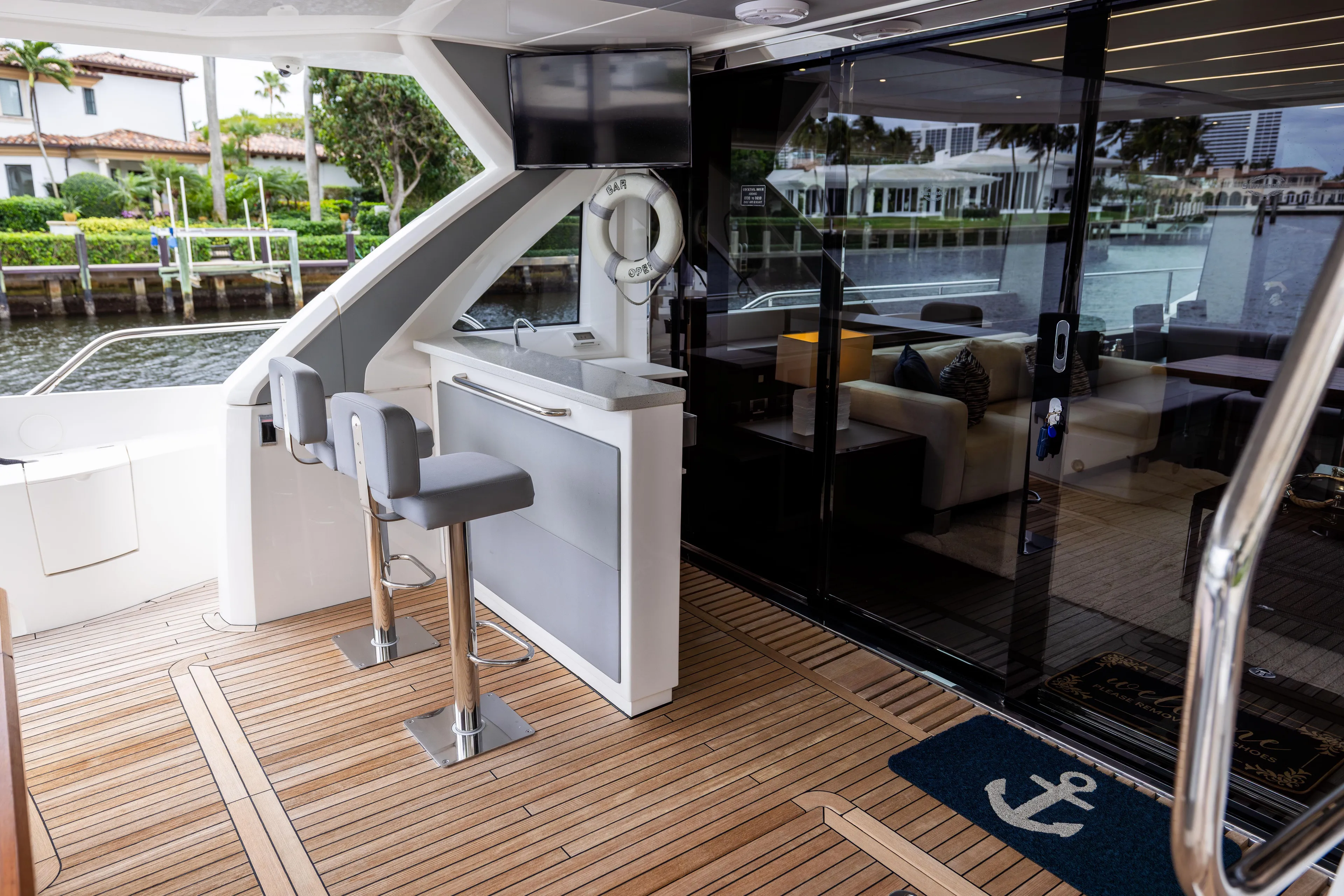 Journey Yacht Photos Pics Luxurious 2019 Sunseeker 76 yacht interior with bar, seating, and waterfront view.