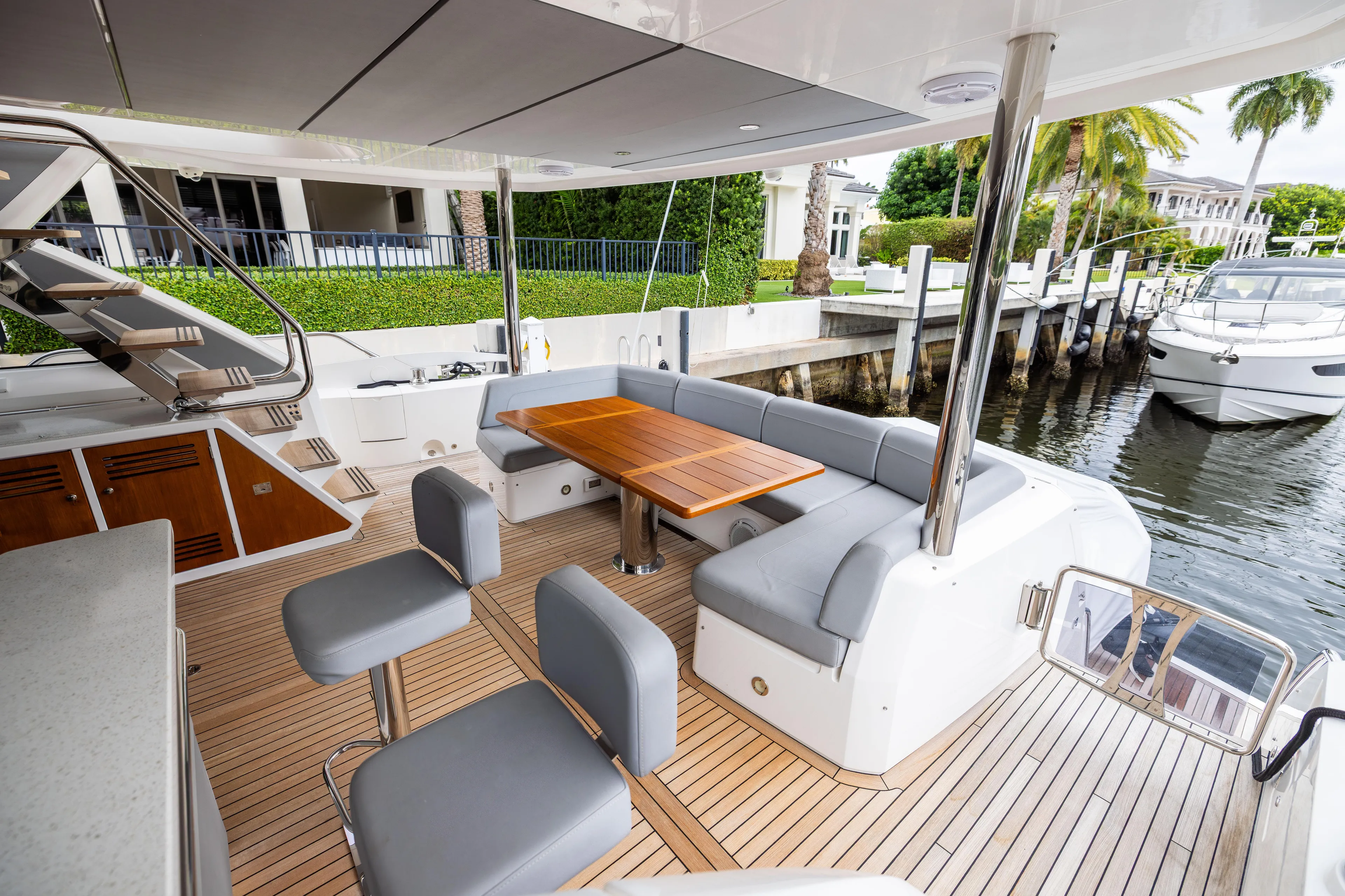 Journey Yacht Photos Pics Luxurious 2019 Sunseeker 76 yacht deck with elegant seating and wooden table.