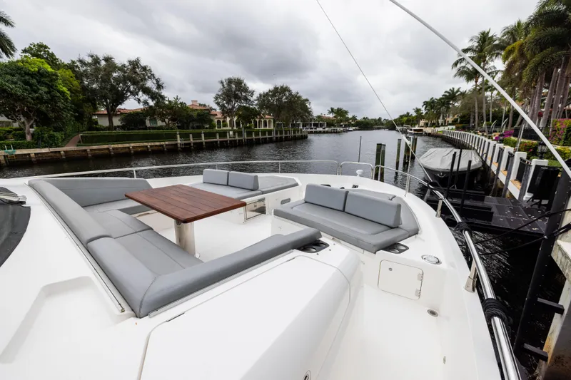 Journey Yacht Photos Pics Luxurious 2019 Sunseeker 76 yacht with spacious deck seating and scenic canal view.