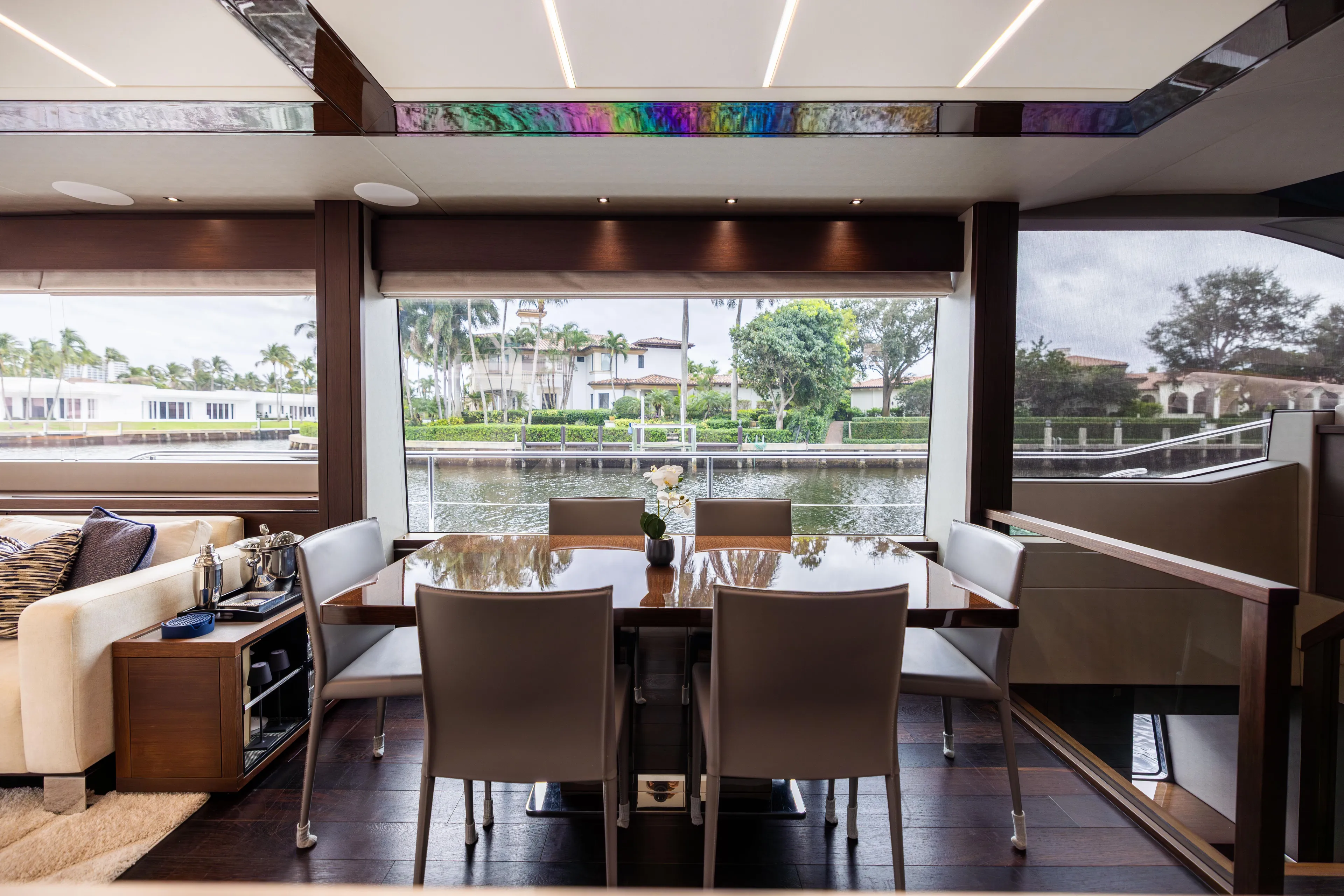 Journey Yacht Photos Pics Luxurious interior of 2019 Sunseeker 76 yacht with elegant dining area and scenic water view.